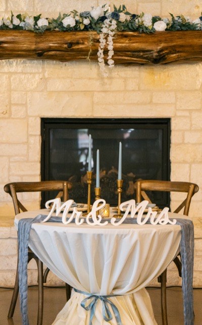 Styled cocktail table with tied linen and wedding decor